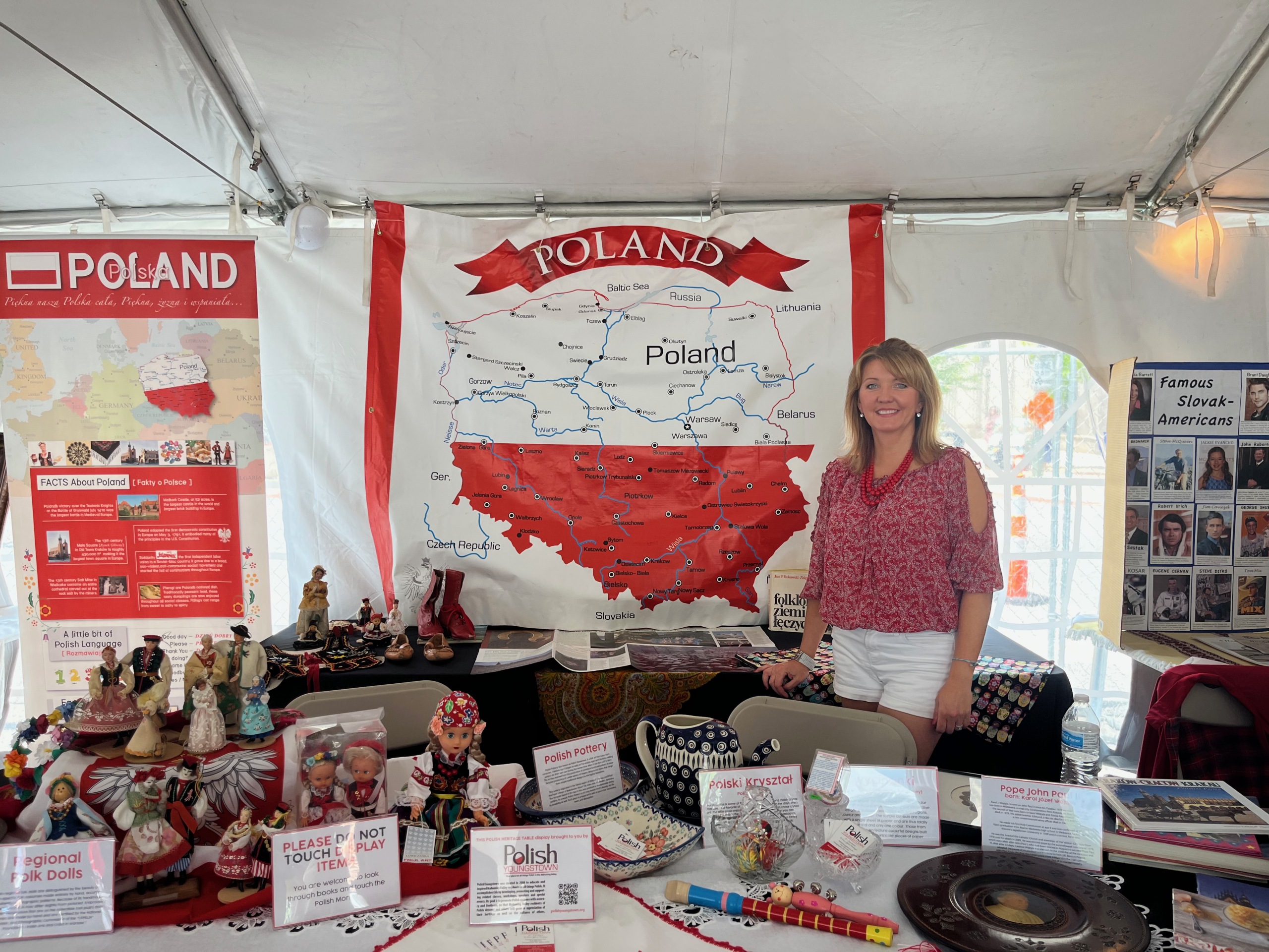 Person standing in front of a map of Poland at a stand